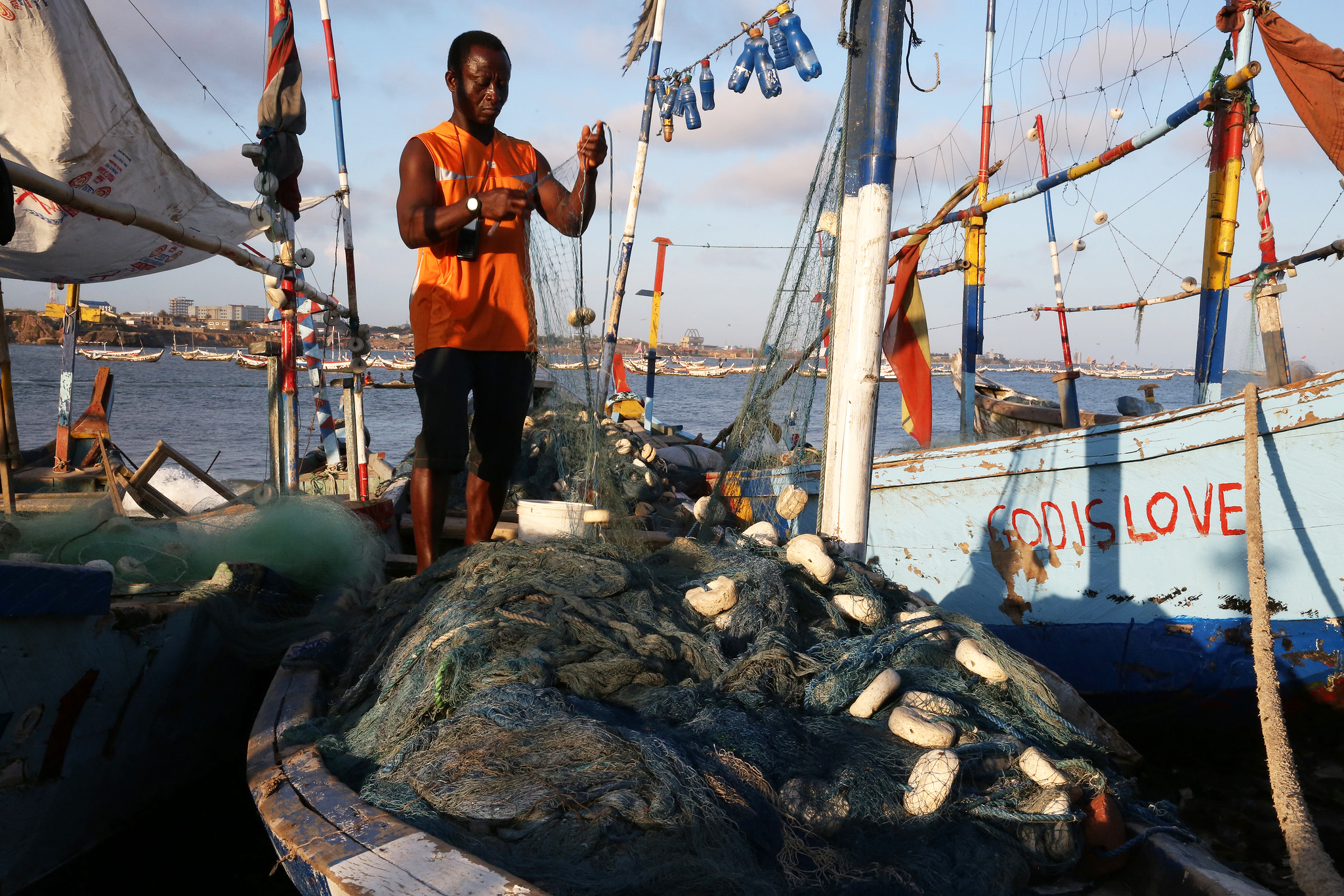 A fisher works on his boat in Accra, Ghana